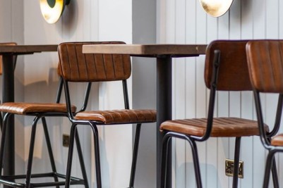 tan-bar-stools-around-bar-table